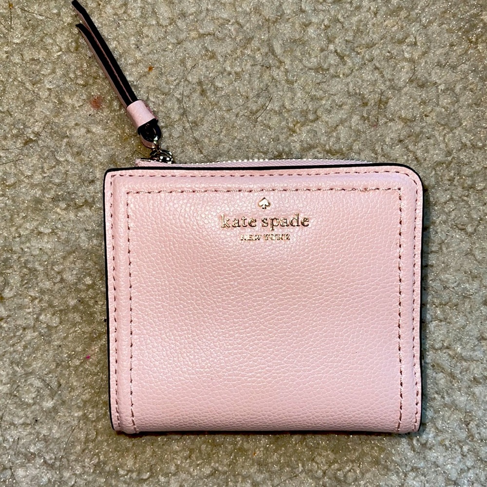 A light pink Kate Spade wallet brand new with tags